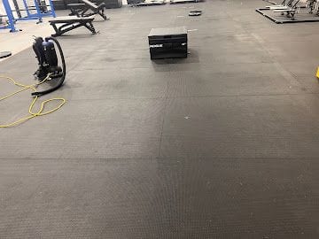 Freshly scrubbed rubber gym flooring after a commercial clean