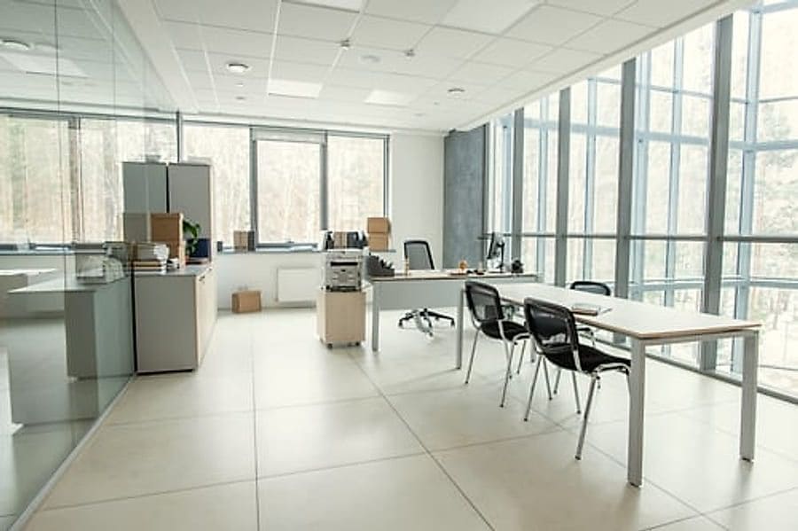 Clean, bright open-plan office workspace with tidy desks