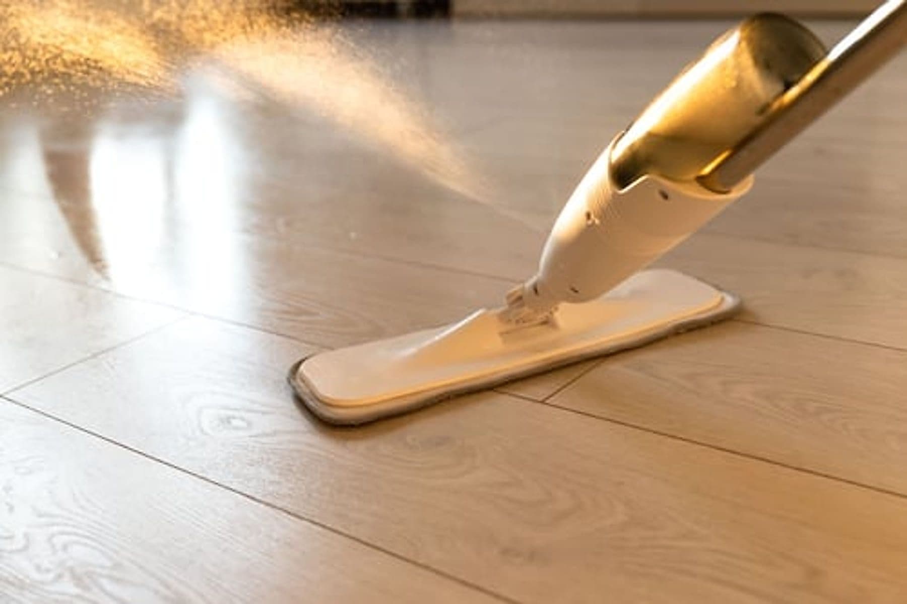 Professional cleaner mopping a hardwood floor in a Jacksonville, FL home