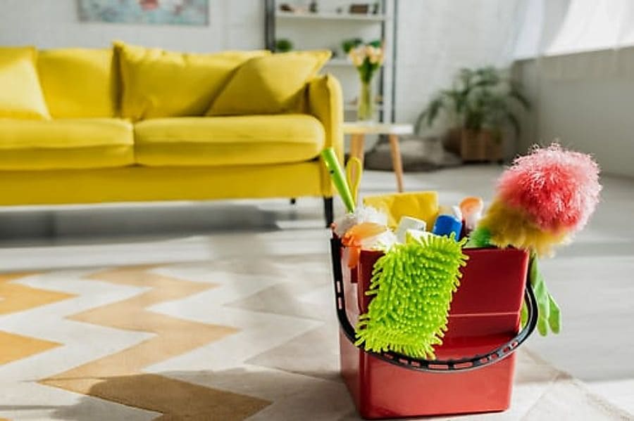Living room with cleaning supplies ready for a professional house cleaning in Jacksonville, FL